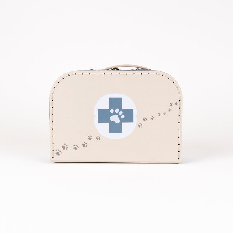 A beige faux-leather case designed like a vintage medicine box, featuring a blue cross with a paw print in the center and a trail of paw prints along the side, set against a plain white background.