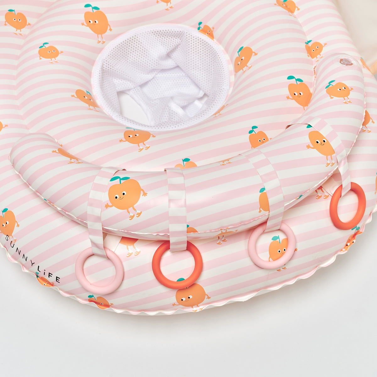 Baby seat with pink and white striped pattern and orange character design on a white background