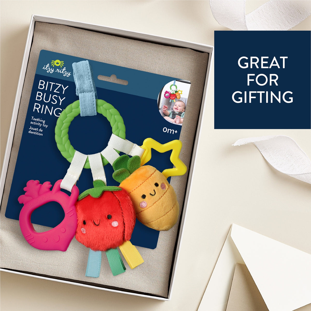 Colorful baby teething ring toy in packaging with 'Great for Gifting' text on a light background