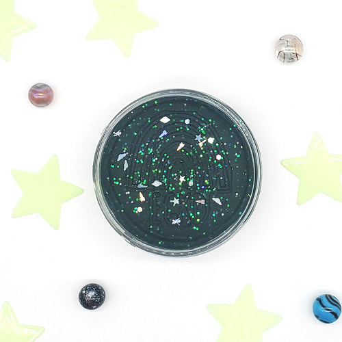 Black glittery container with stars and planets on a white background with star decorations
