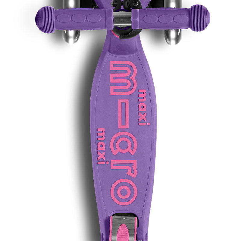 Purple scooter with pink 'Maxi Micro' branding on a white background