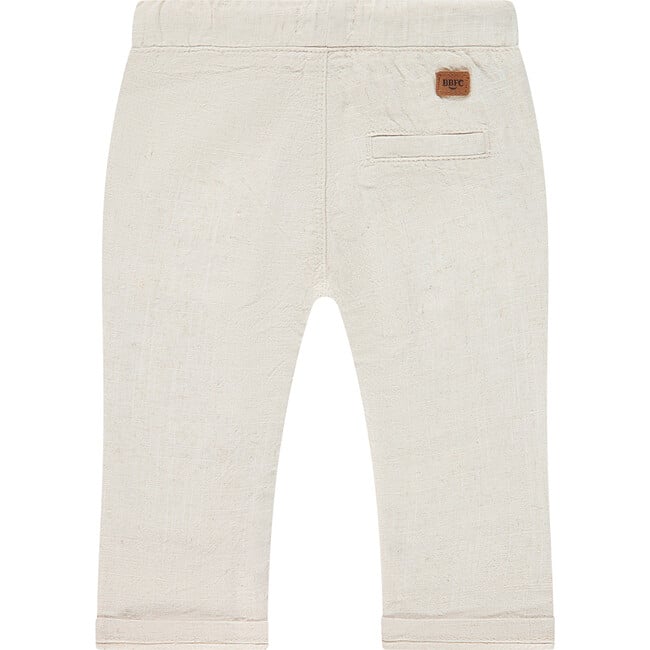 Beige pants with a brand label on a white background