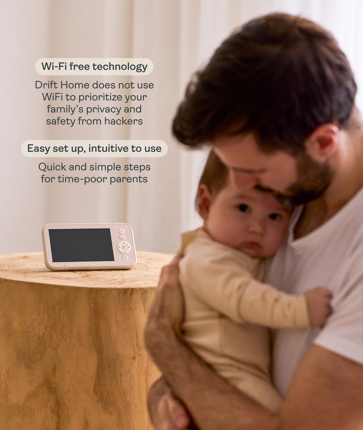 Man holding a baby next to a digital device with text about Wi-Fi-free technology.