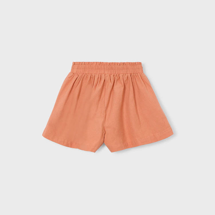 Orange shorts on a light gray background