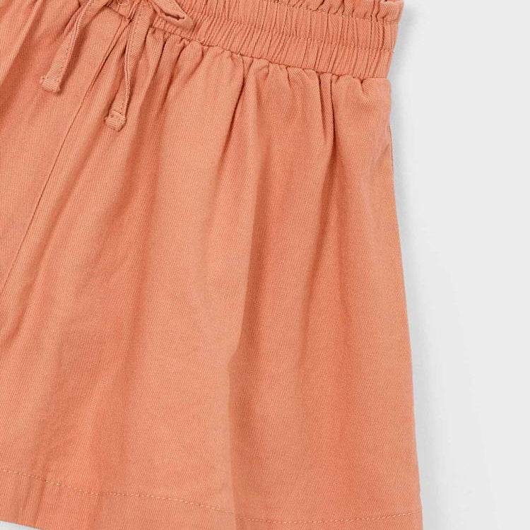 Coral-colored shorts with a drawstring on a white background