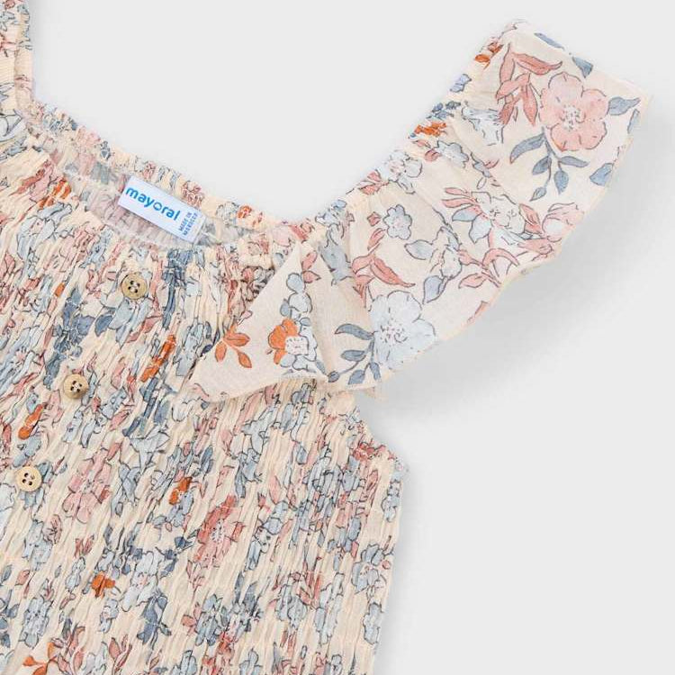 Floral dress with a brand label on a light gray background