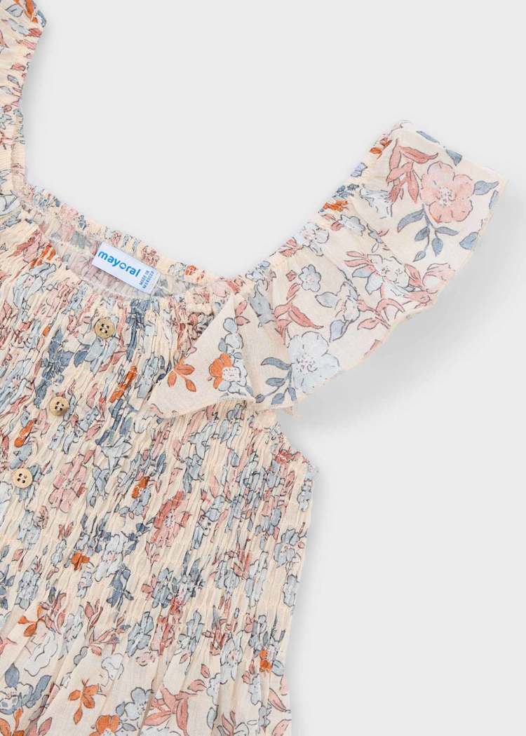 Floral dress with a brand label on a light gray background