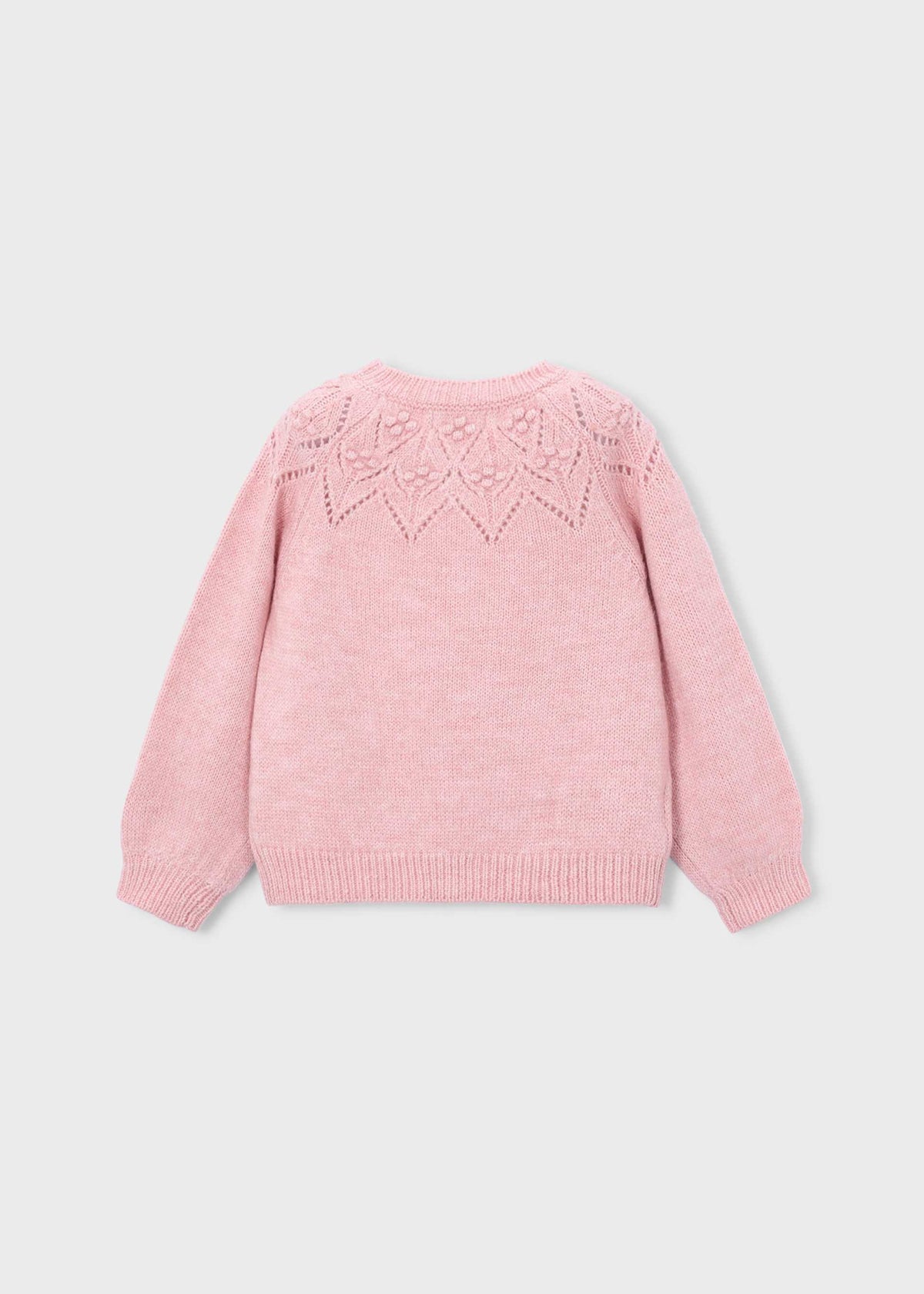 A light pink knit sweater shown from the back, featuring a delicate geometric lace-knit pattern across the upper back, set against a solid light gray background.