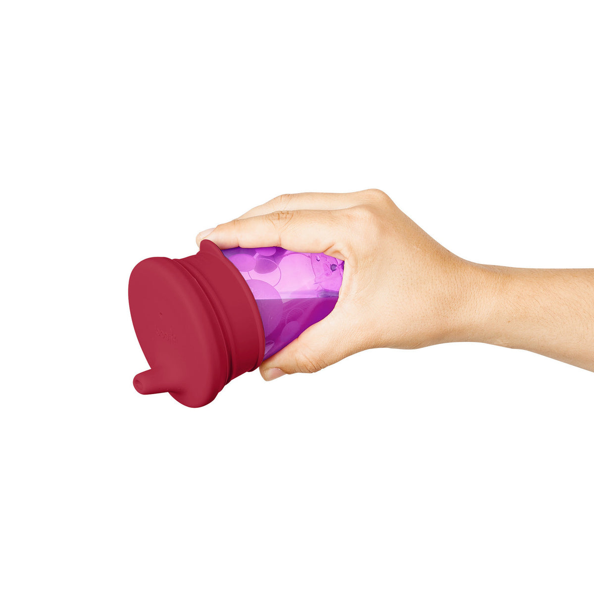 Hand holding a purple and red container on a white background