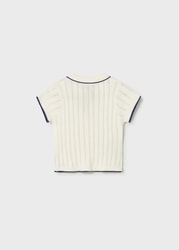 White ribbed knit t-shirt with black trim on a light gray background