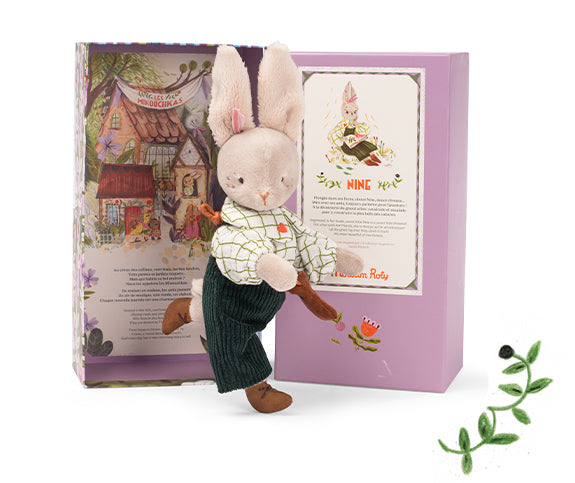 Stuffed rabbit toy with a book in a decorative box on a white background