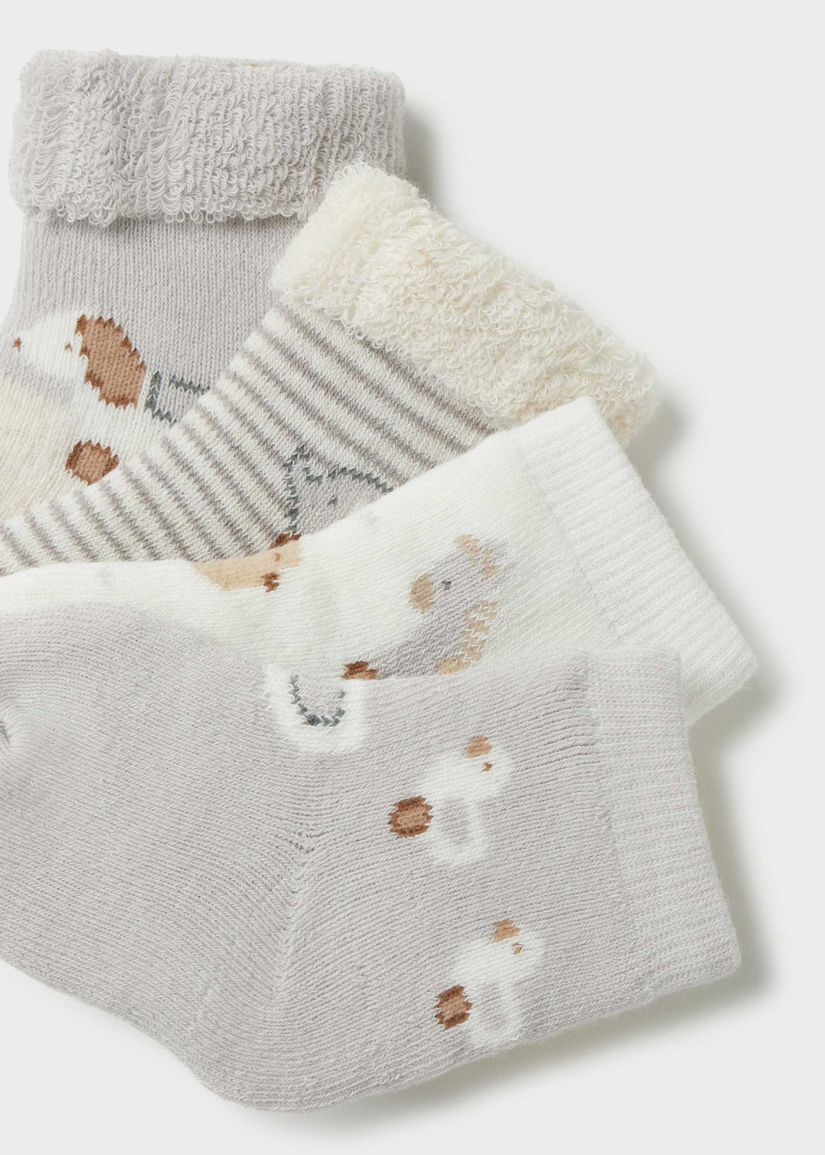 Set of baby socks with hedgehog design on a light gray background