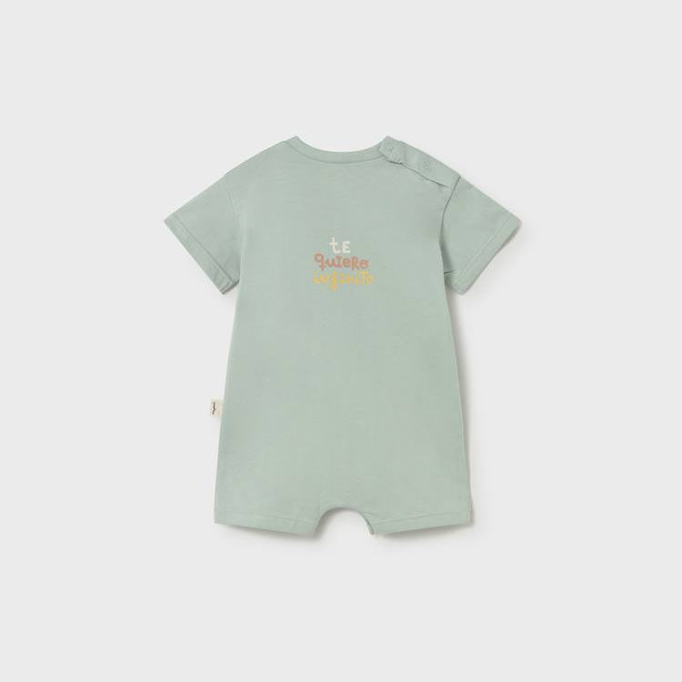 Light green baby romper with text on a white background