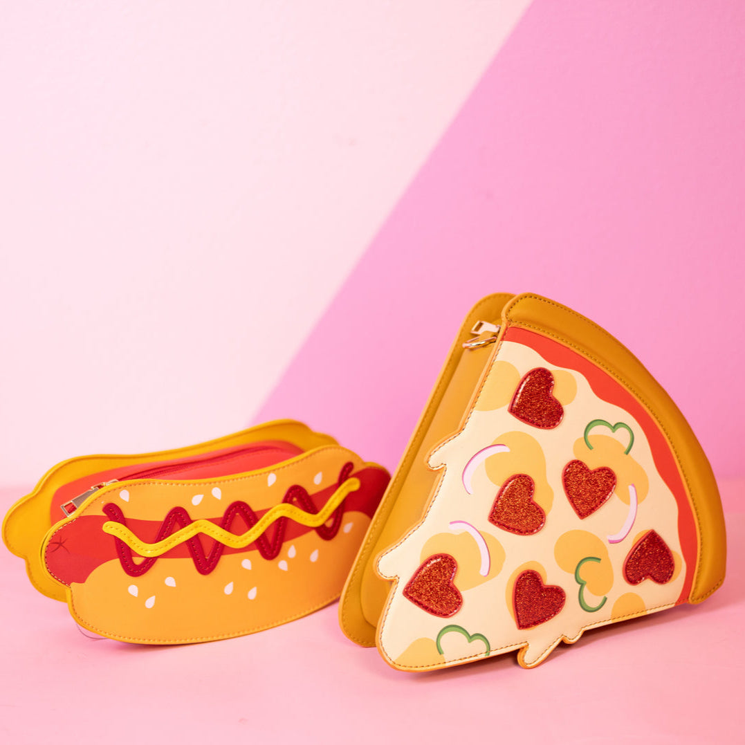Two novelty pouches shaped like a pizza slice and a hot dog on a pink background