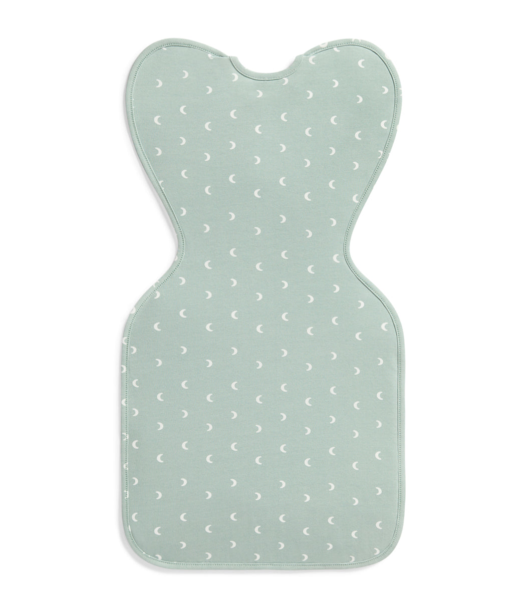 Light green baby mat with white moon pattern on a white background