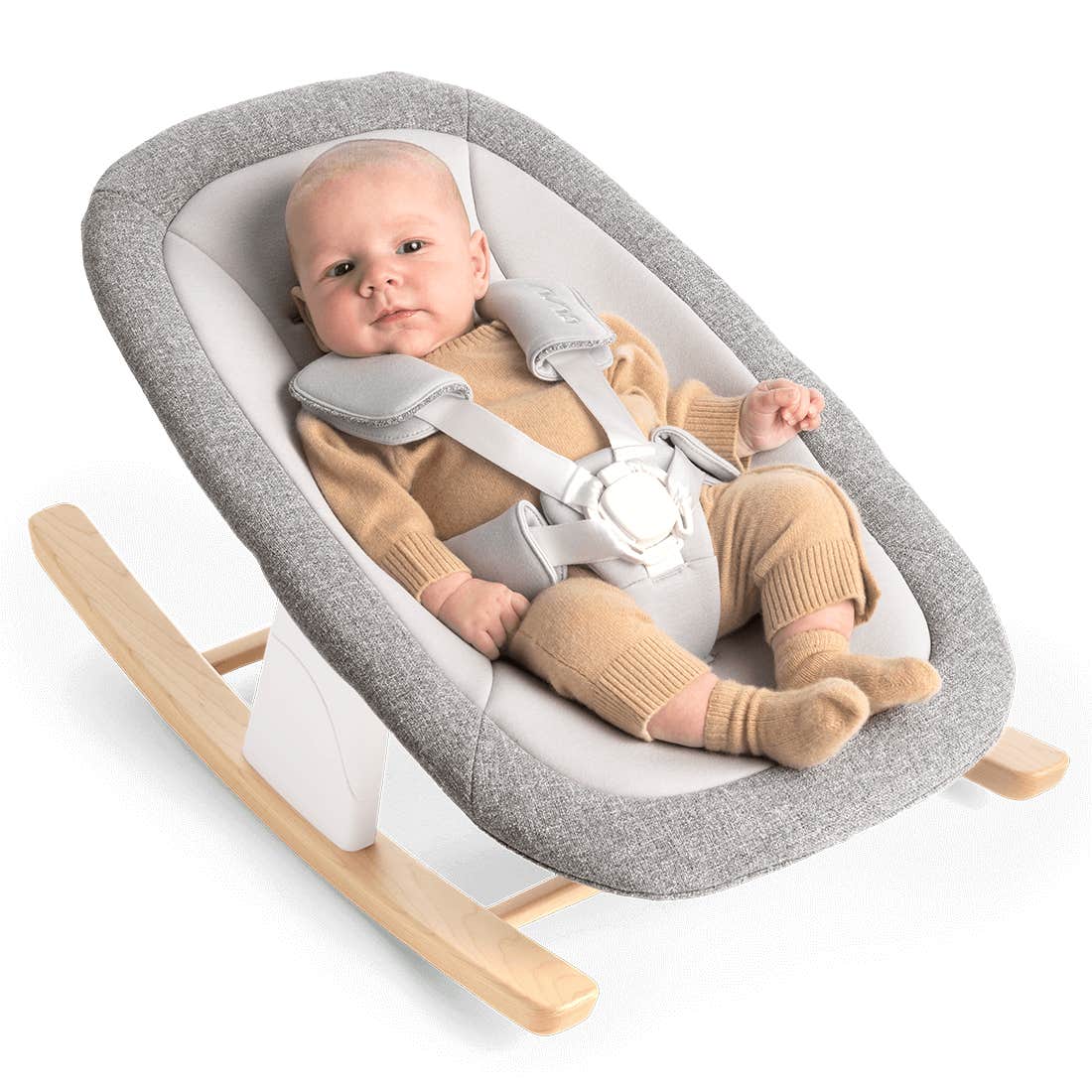 Baby in a gray and white baby bouncer with wooden legs on a white background