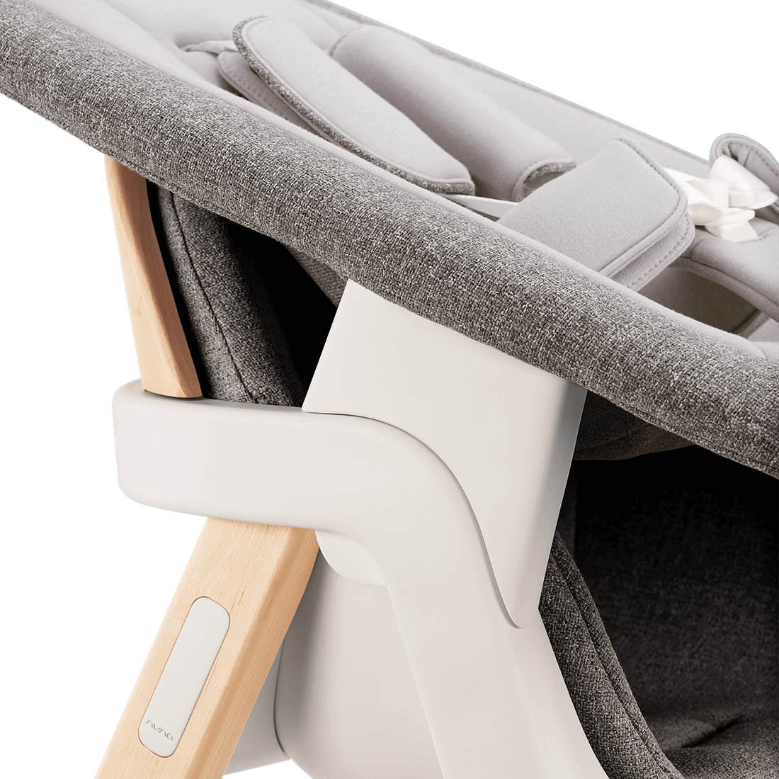 Close-up of a baby seat with gray cushion and wooden armrest on a white background