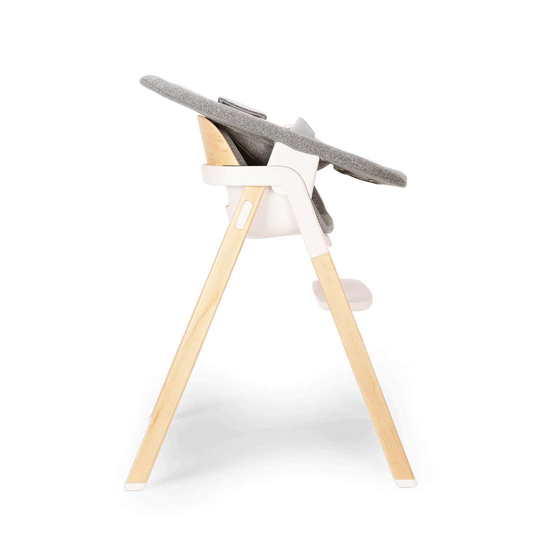 High chair with wooden legs and gray cushion on a white background