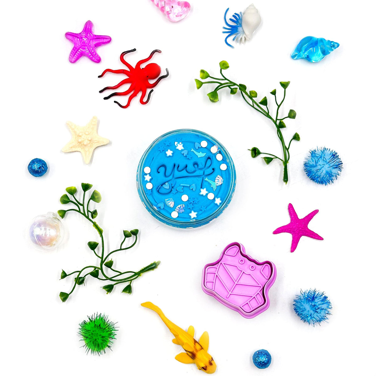 Colorful sea-themed toys and accessories on a white background