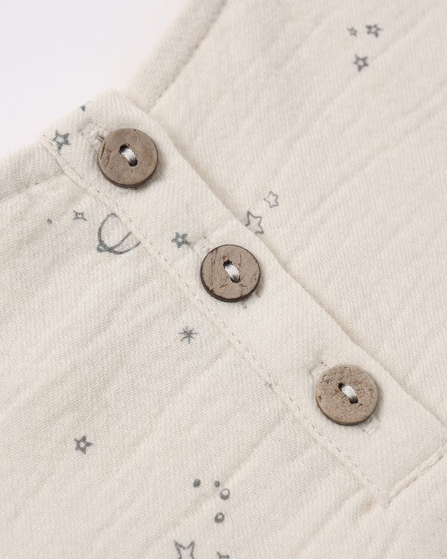 Close-up of a textured fabric with button details and star patterns.