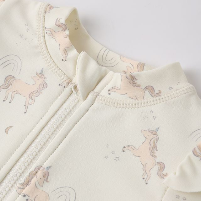 Baby outfit with unicorn pattern on a light background