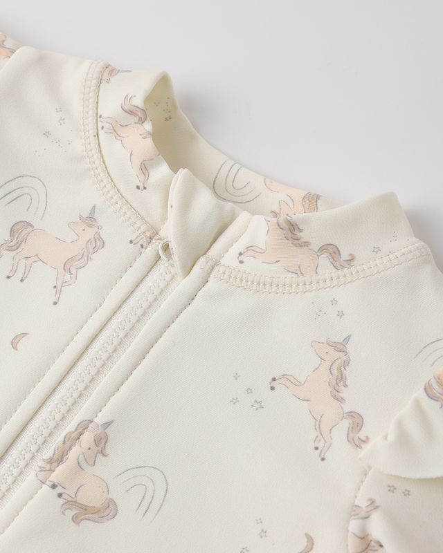 Baby outfit with unicorn pattern on a light background
