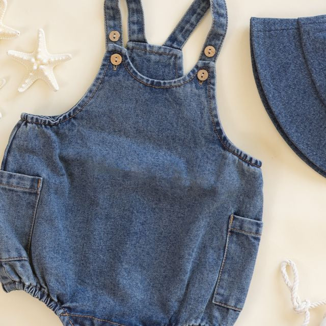 Denim romper with button details on a light background