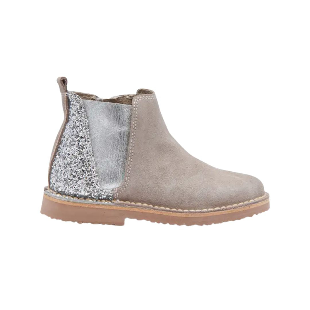 A single children's Chelsea-style ankle boot in taupe suede with a silver glitter side panel and elastic gore, shown in side profile on a white background.