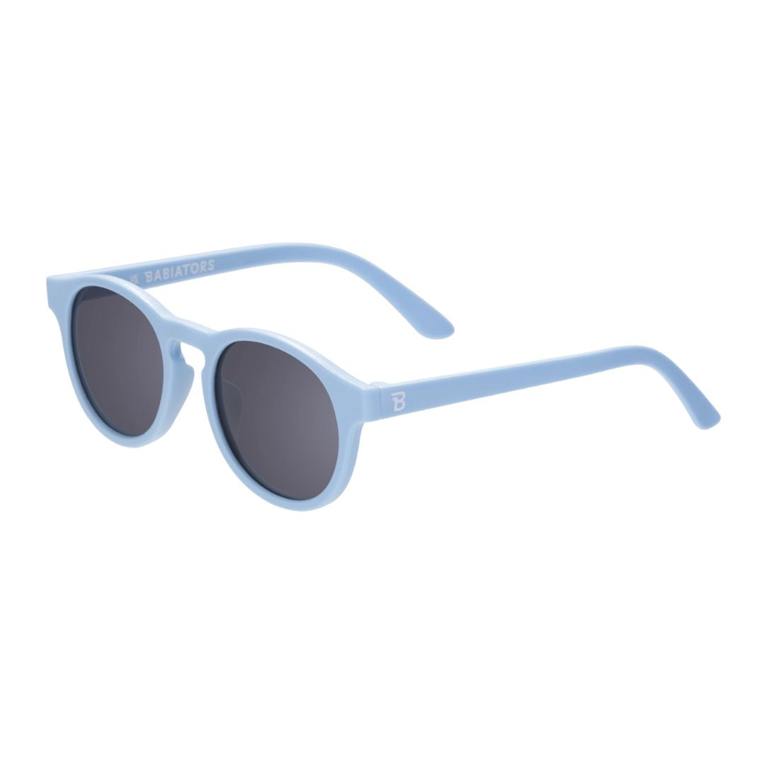 Light blue sunglasses with dark lenses on a white background