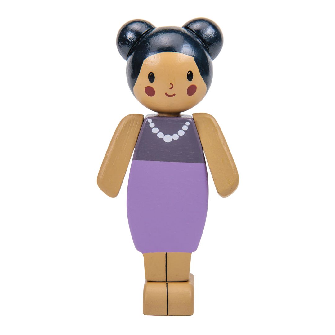A wooden doll figure with a tan body, dark blue hair in two buns, a purple dress, and a white beaded necklace, shown against a plain white background.