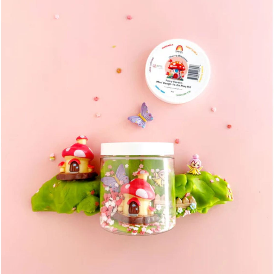 Fairy house kit with a jar on a pink background