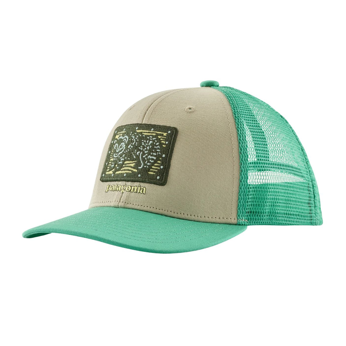 A Patagonia trucker hat with a beige front panel and brim, a green mesh back, and a green rectangular logo patch on the front.