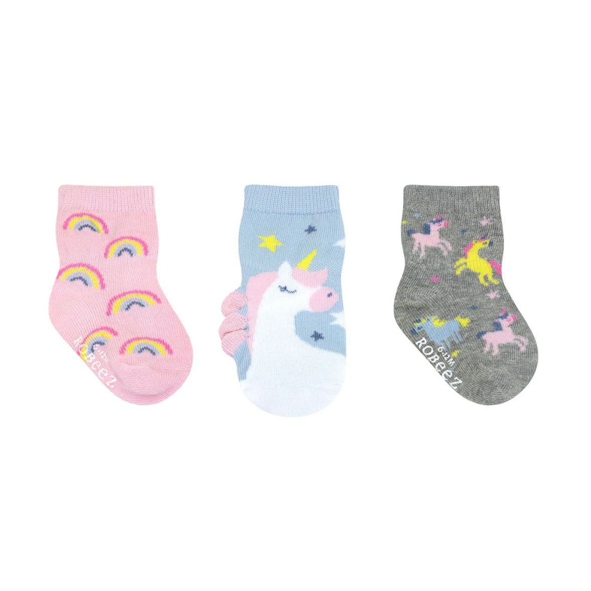 Three pairs of children's socks with unicorn and rainbow designs on a white background