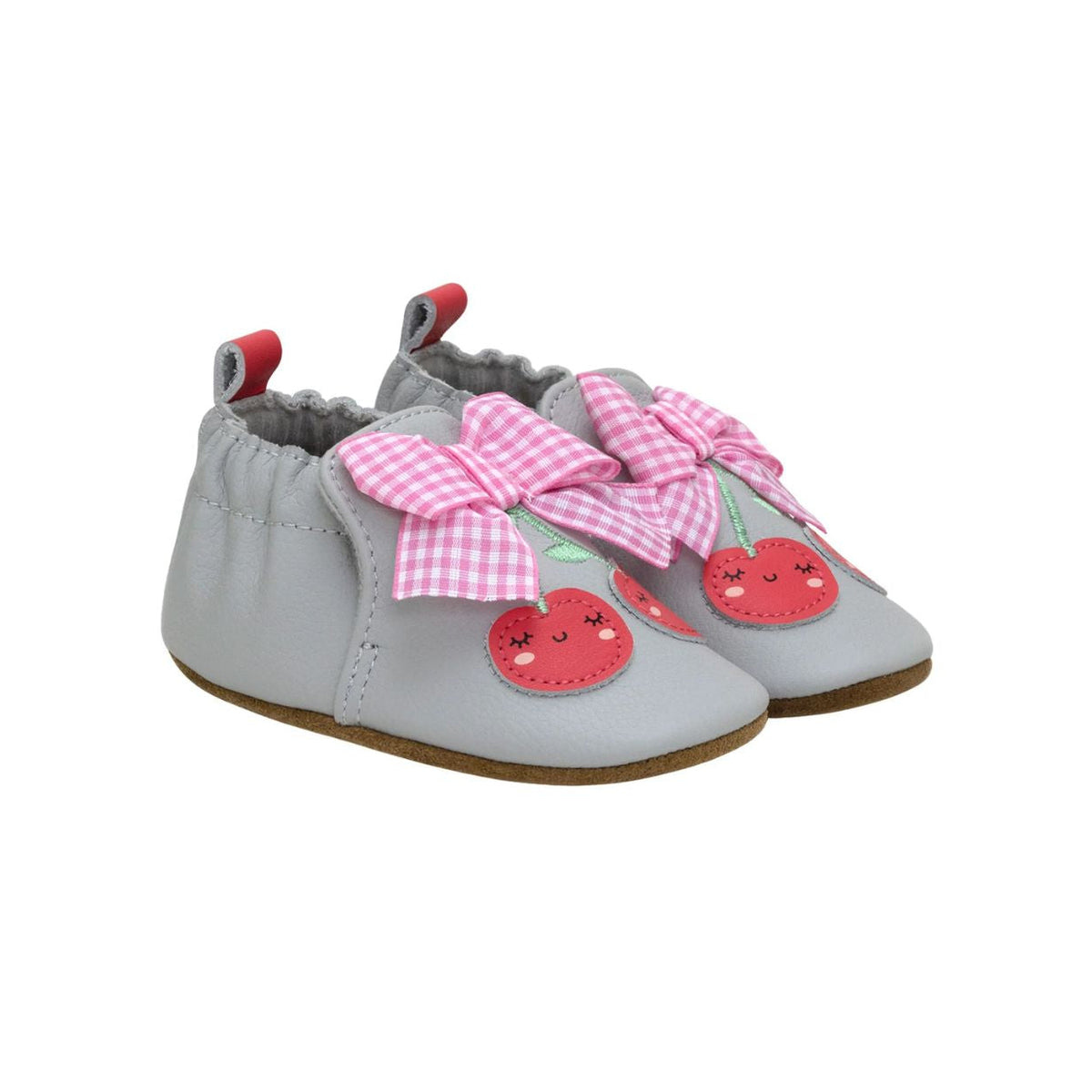 Gray baby shoes with pink bows and red accents on a white background