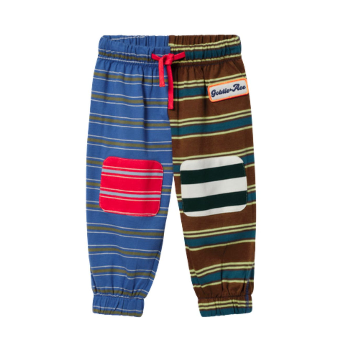 A pair of children's jogger pants with a split design: one leg has blue, brown, and beige stripes with a red patch pocket, and the other leg has brown, green, beige, and white stripes with a white patch pocket. It features an elastic waistband with a red drawstring and a 'Bustle-Rose' brand patch.