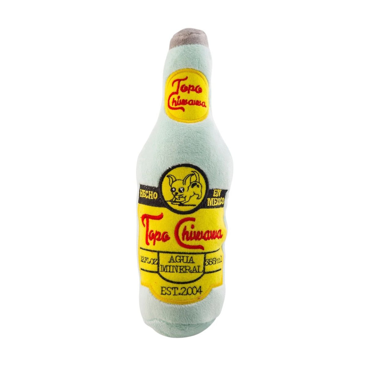 A plush dog toy shaped like a Tapa Chihuahua mineral water bottle, featuring a light blue-green body with yellow and black labels and a brown faux-fur cap, isolated on a white background.
