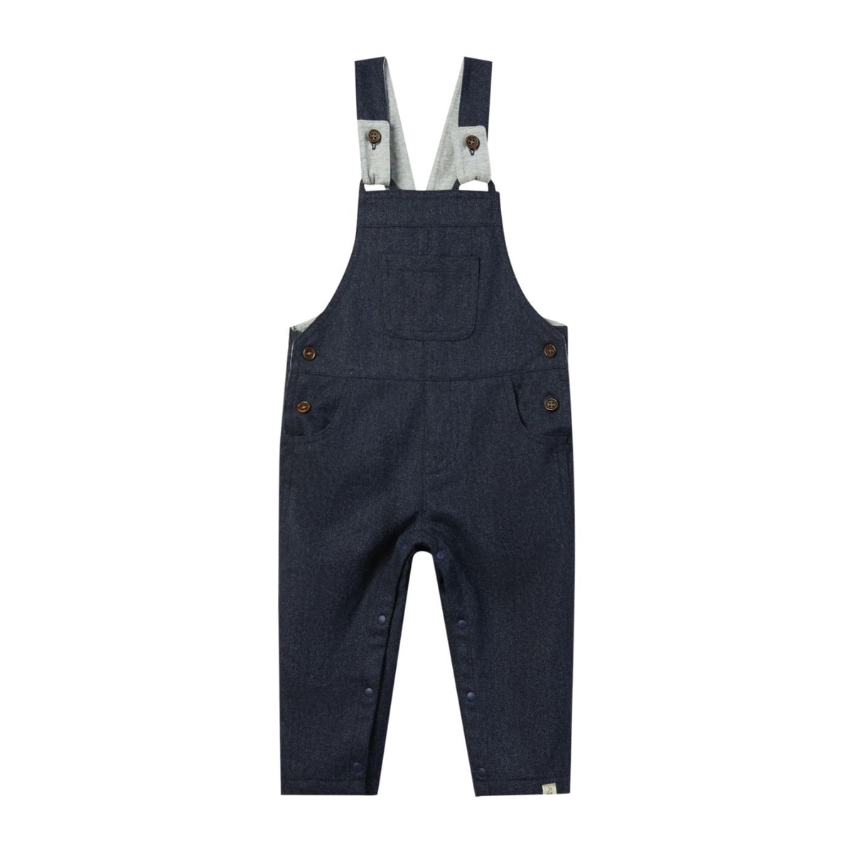 A pair of dark navy blue denim baby overalls with adjustable suspenders, front patch pocket, and side button closures, shown flat on a white background.