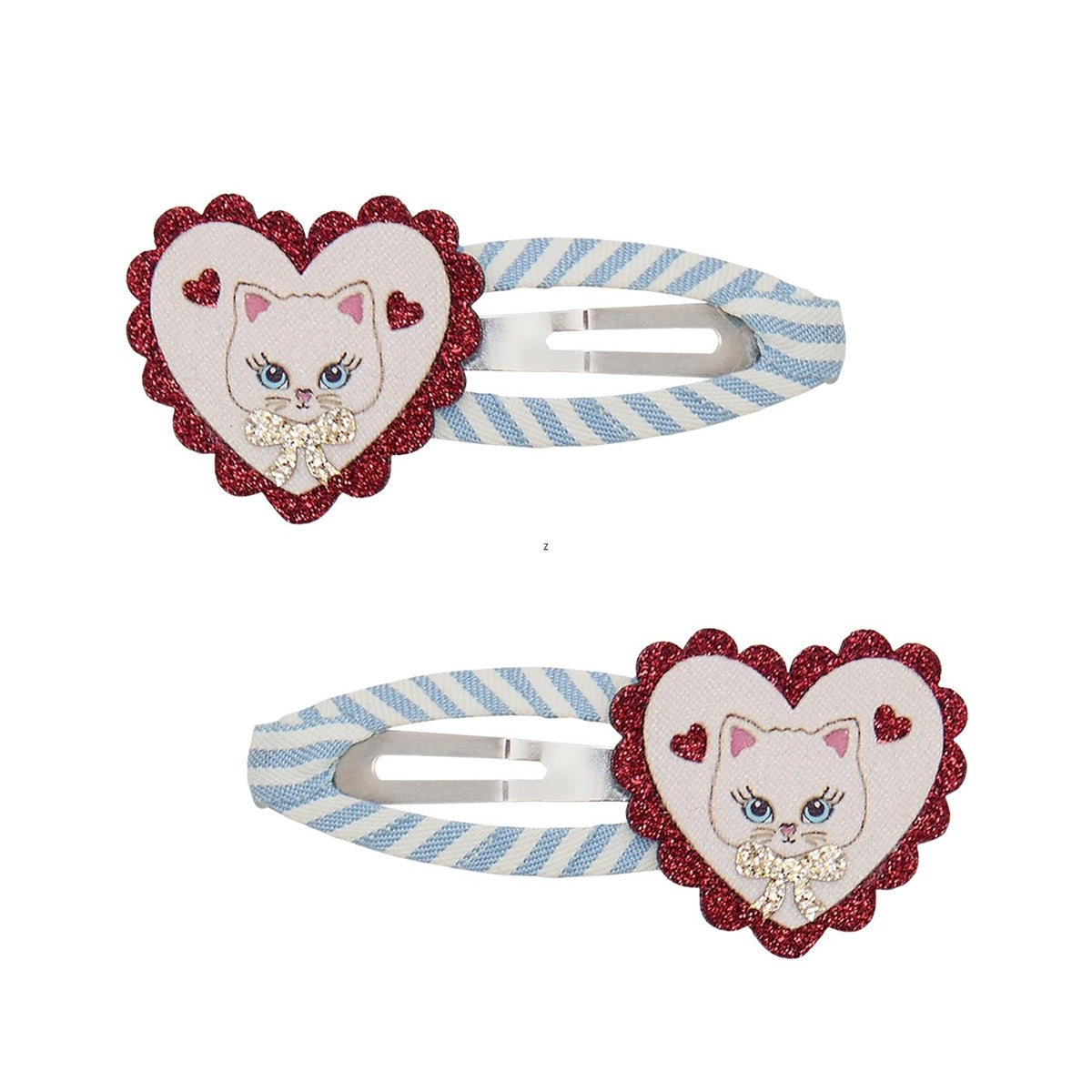 Two matching hair clips on a white background, each featuring a heart-shaped embellishment with a white cat face, blue eyes, pink nose, and rhinestone necklace, set against a red glitter border. The clips have a light blue and white striped fabric band with a silver metal spring.