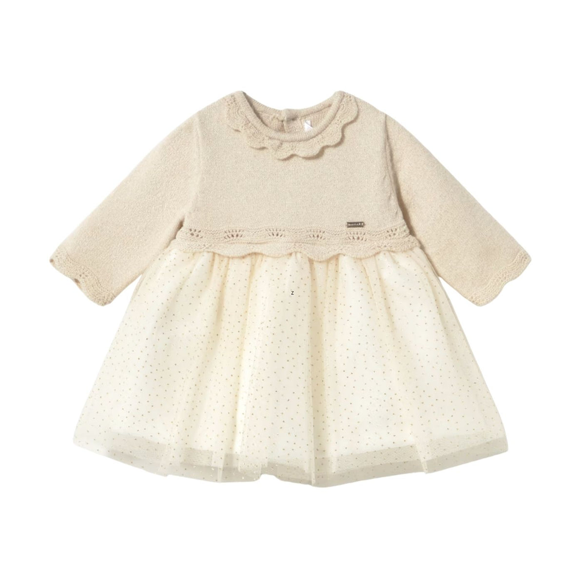 A cream-colored baby girl's dress featuring a textured knit long-sleeve top with a scalloped ruffle collar, a lace-trimmed waist, and a dotted tulle skirt, shown against a plain white background.