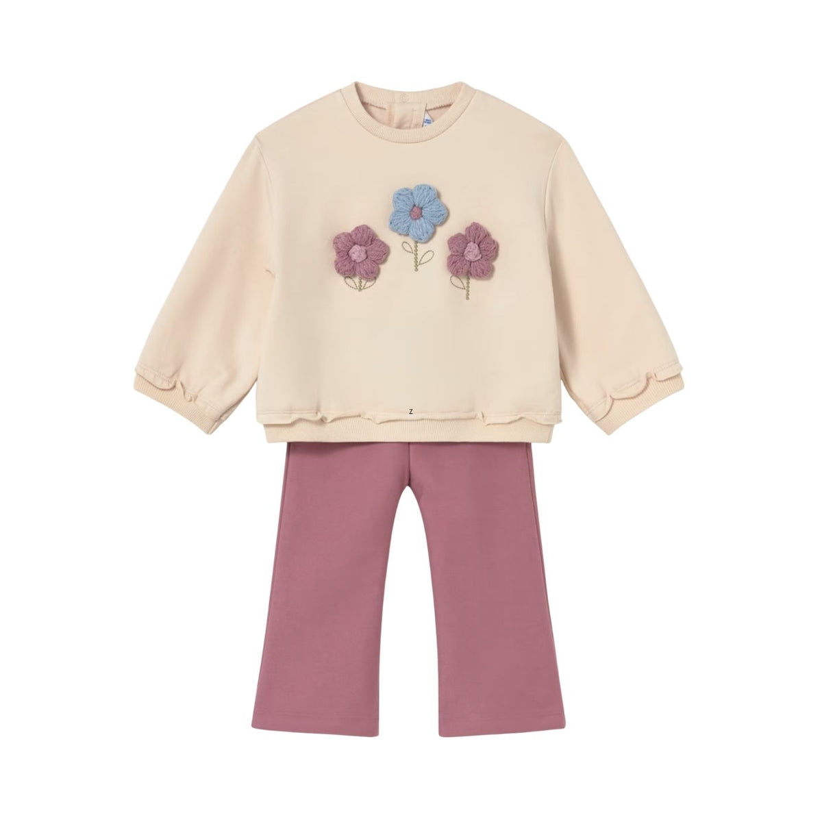 A children's two-piece outfit featuring a cream-colored long-sleeve top with three embroidered flowers (blue, purple, and pink) on the chest, paired with dusty rose pants, shown against a plain white background.