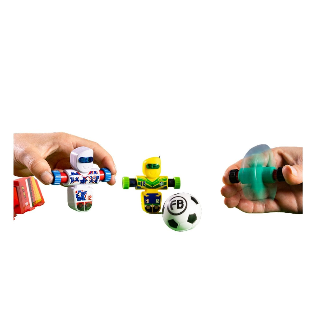 A set of small toy gadgets shown on a white background, including a hand holding a white robot figure with blue and red accents, a yellow and green robot figure, a black-and-white soccer ball with 'FB' printed on it, and a translucent green squeeze bulb held in a hand.