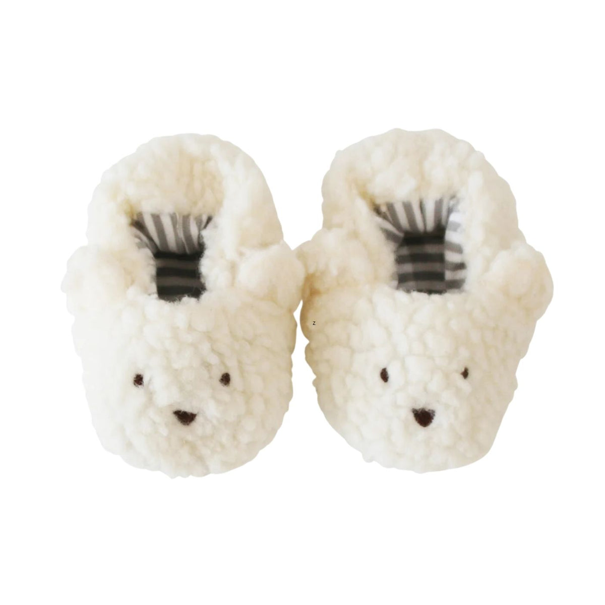 Pair of white fuzzy slippers with black accents on a white background