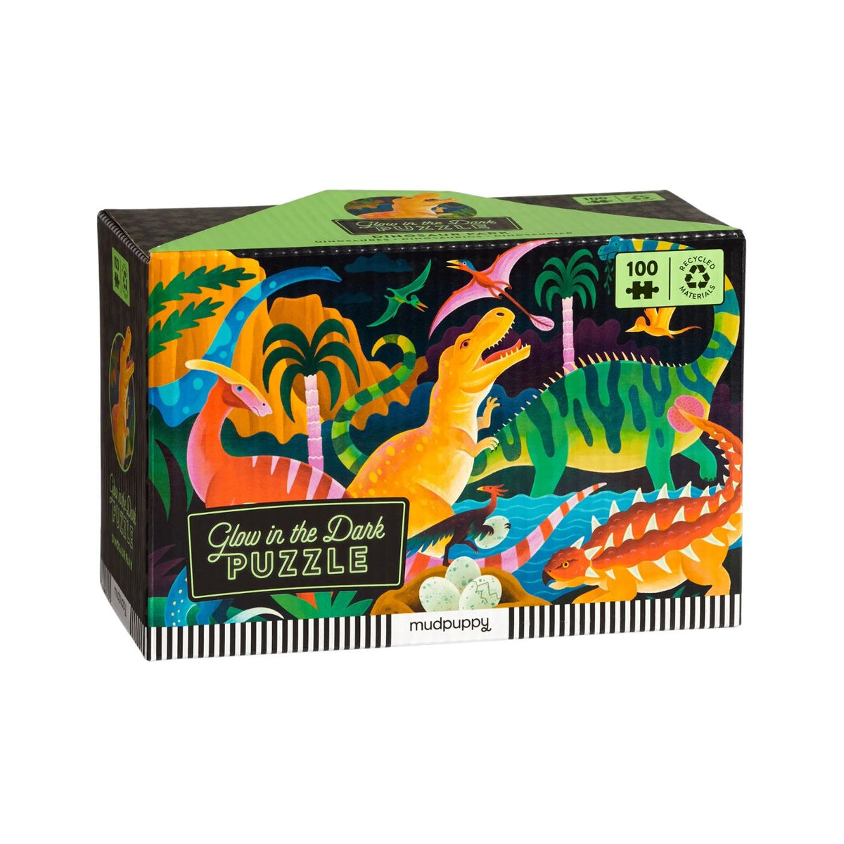 A product photo of the Dinosaur Park 100 Piece Glow in the Dark Puzzle by Mudpuppy box against a white background, featuring illustrated prehistoric dinosaurs and a "Glow in the Dark PUZZLE" label on the front.