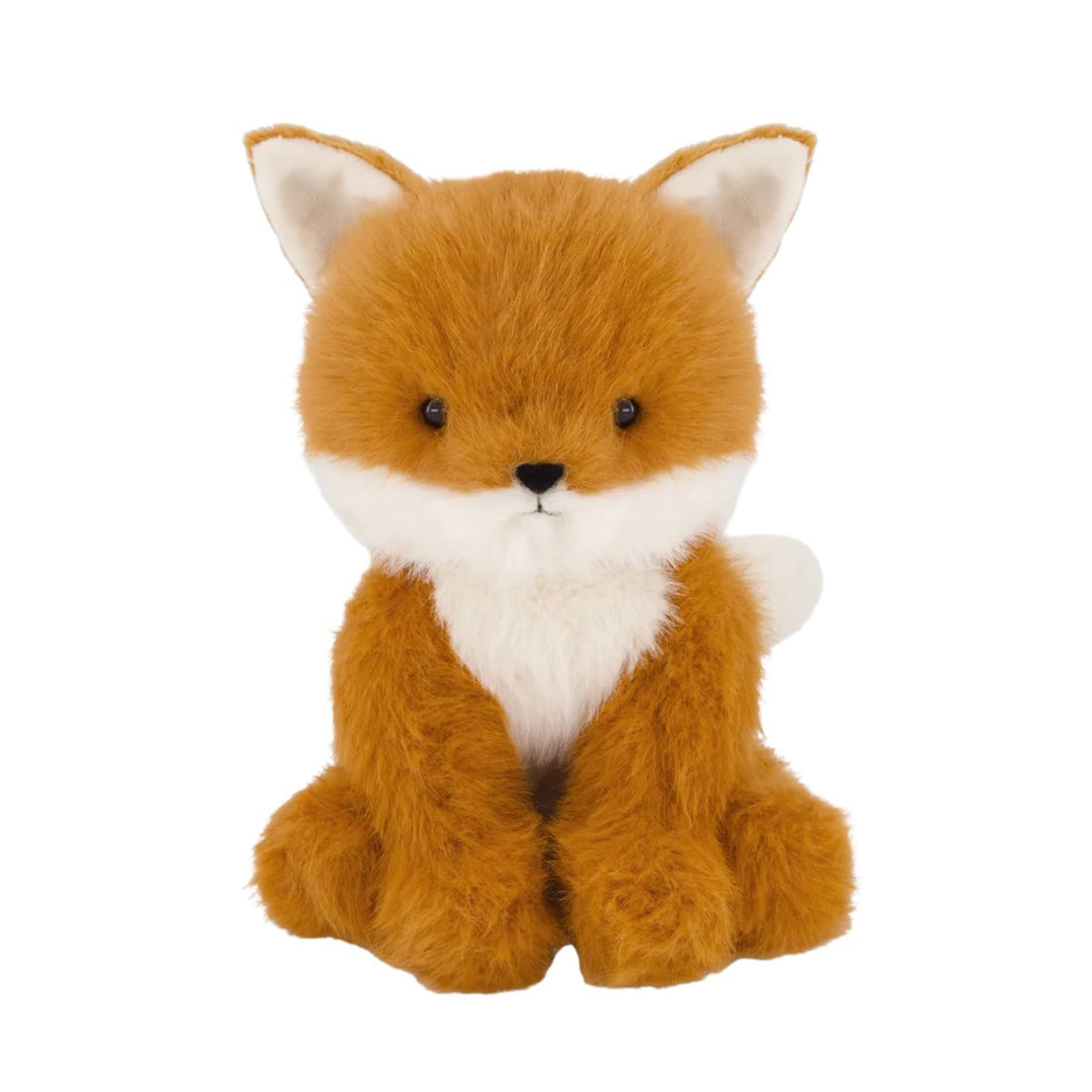 Plush toy fox with fluffy rust-colored and natural-toned fur, a soft cream-colored chest, small dark eyes, a stitched black nose, and a gentle expression, sitting upright against a plain white background.