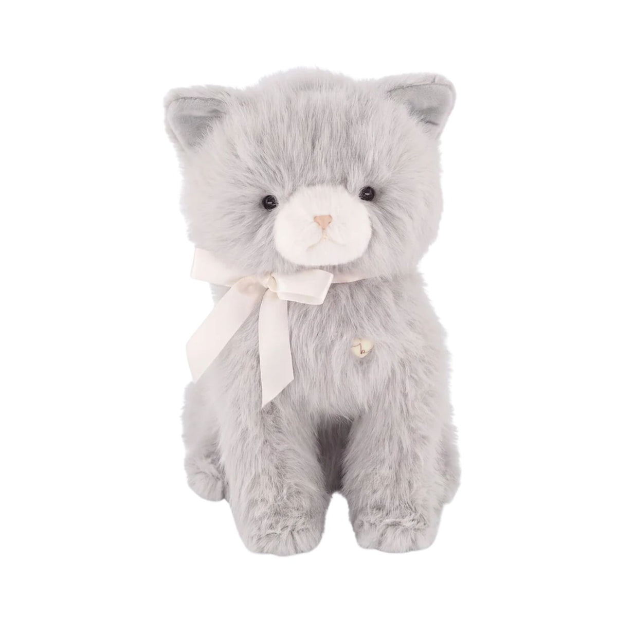 A soft grey plush kitten toy sitting upright, featuring a cream-colored muzzle with delicate embroidered facial details and a white satin ribbon bow tied around its neck.