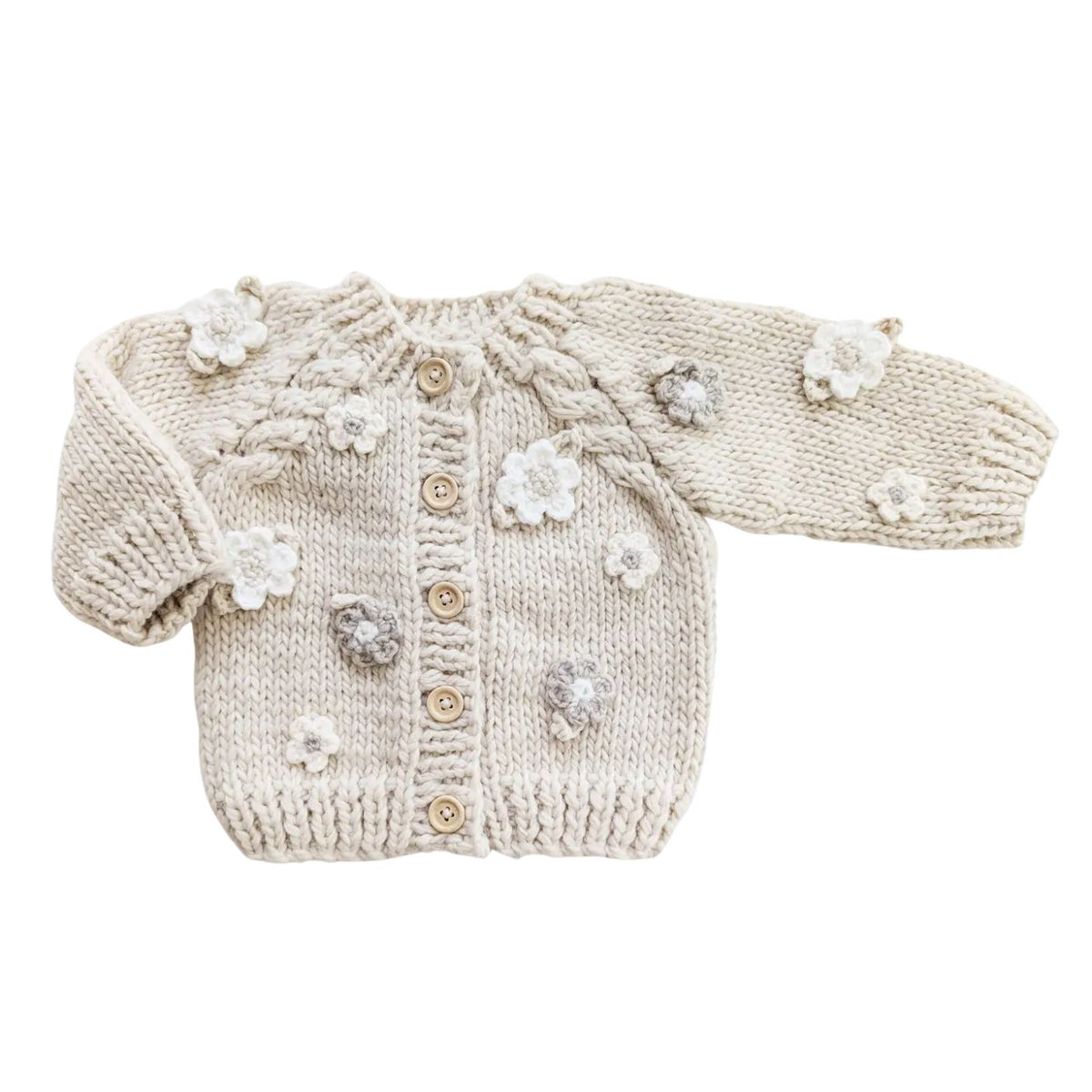 Knitted baby cardigan with floral and button details on a white background