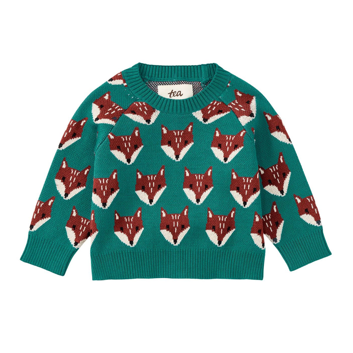 A front view of the Family Fox Sweater - Foxwood Fair Isle by Tea Collection, featuring an emerald green knit background patterned with rows of repeating, stylized red-and-white fox faces across the chest and sleeves, set against a plain white background.