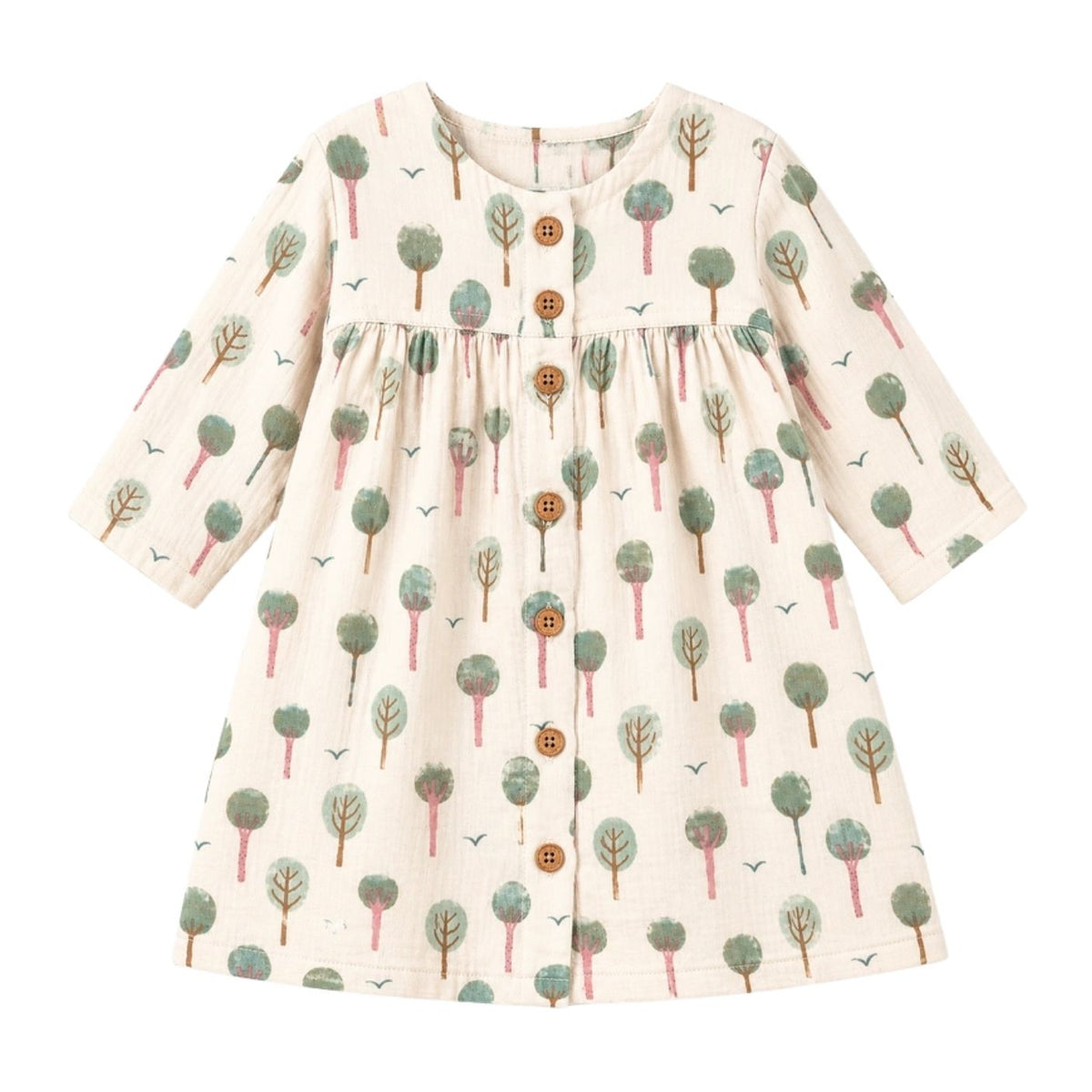 A long-sleeve baby dress with an all-over tree print on a cream-colored fabric, featuring brown buttons down the front and a gathered waist.