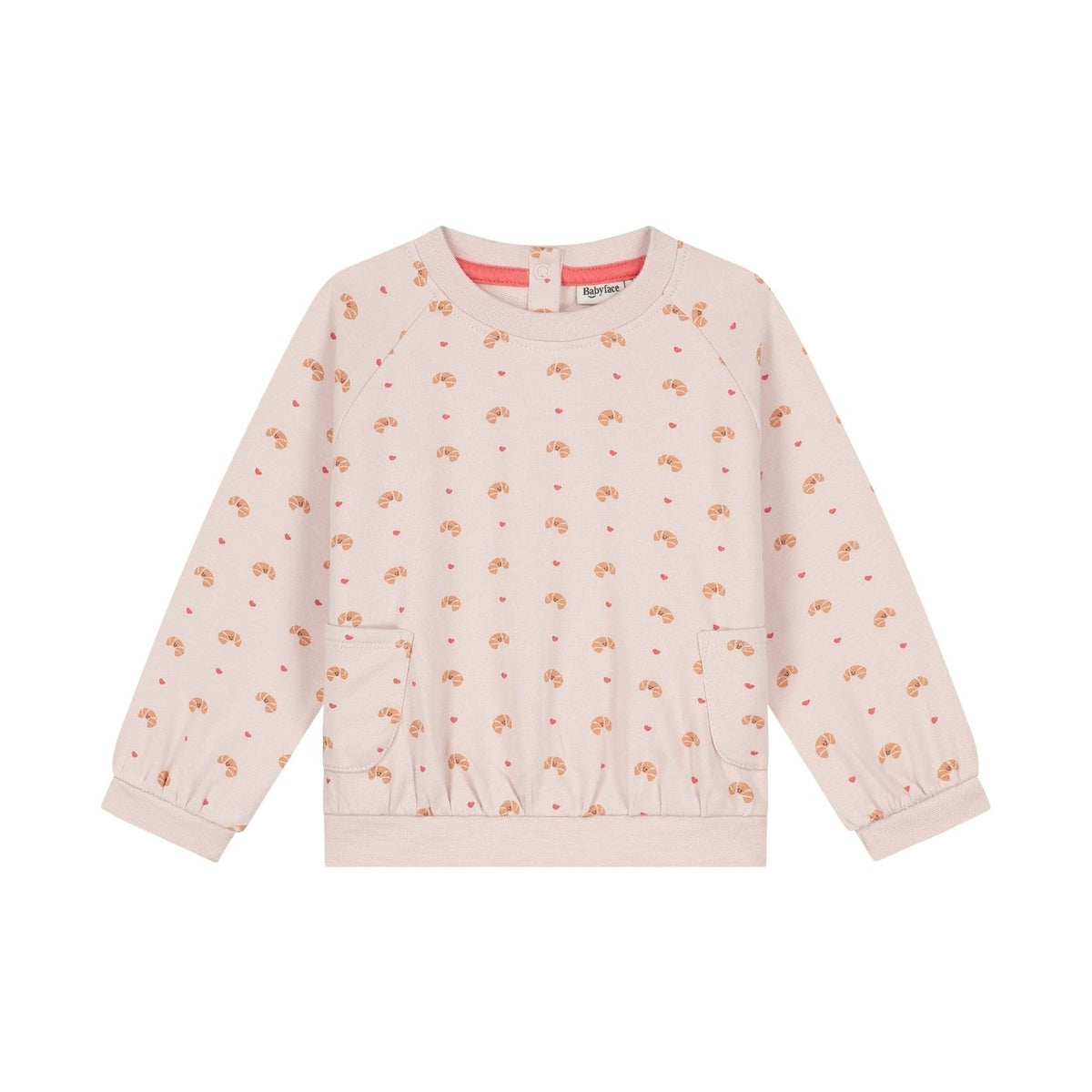 A light pink long-sleeve sweatshirt for children, featuring an all-over print of small teddy bears and hearts in brown and red, with a coral pink inner collar lining. The sweatshirt has a crew neck, ribbed cuffs, and front patch pockets, shown flat on a white background.