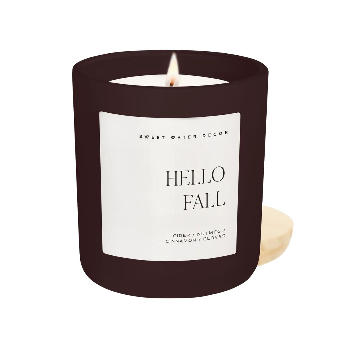 Candle with 'Hello Fall' label on a white background